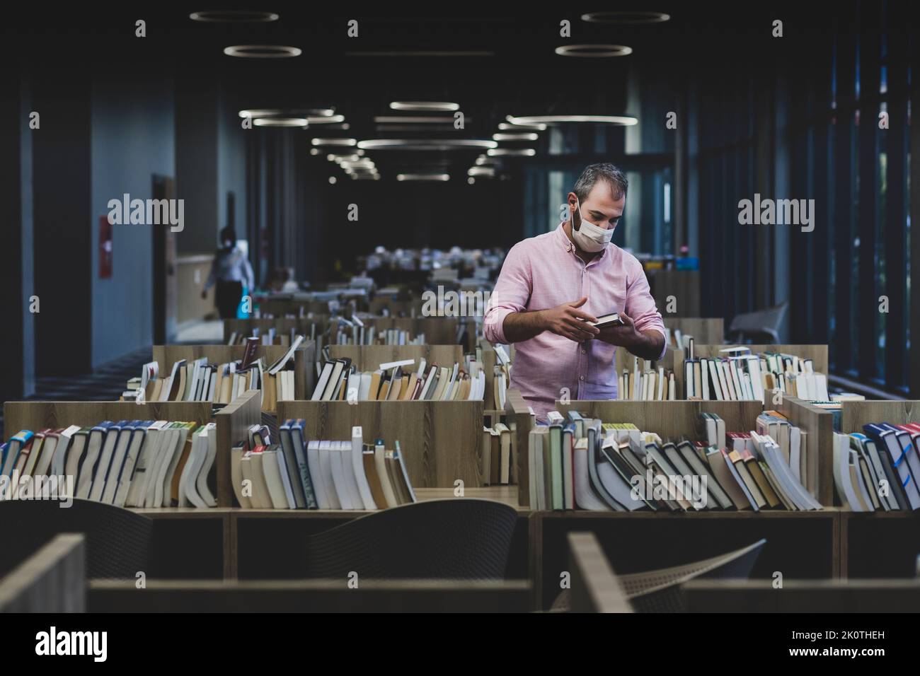 College student reading books in a library Stock Photo