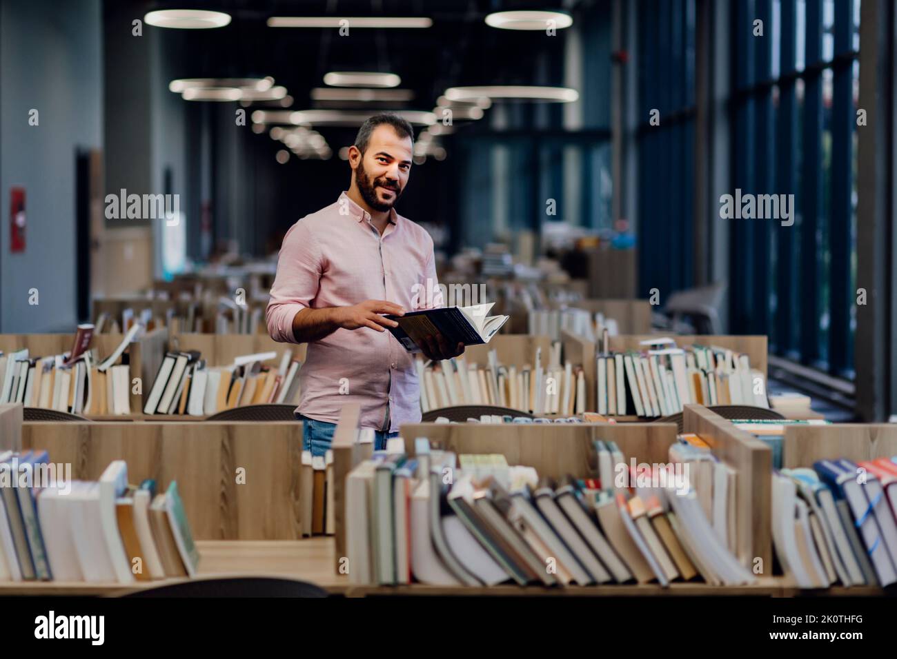 College student reading books in a library Stock Photo