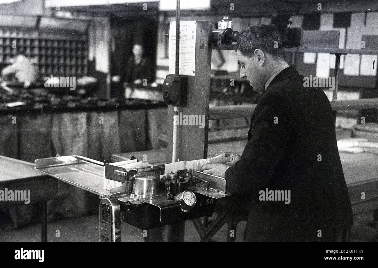 1950s, historical, a male postal worker in a sorting office using a small desk-top letter machine, London, England, UK. Stock Photo