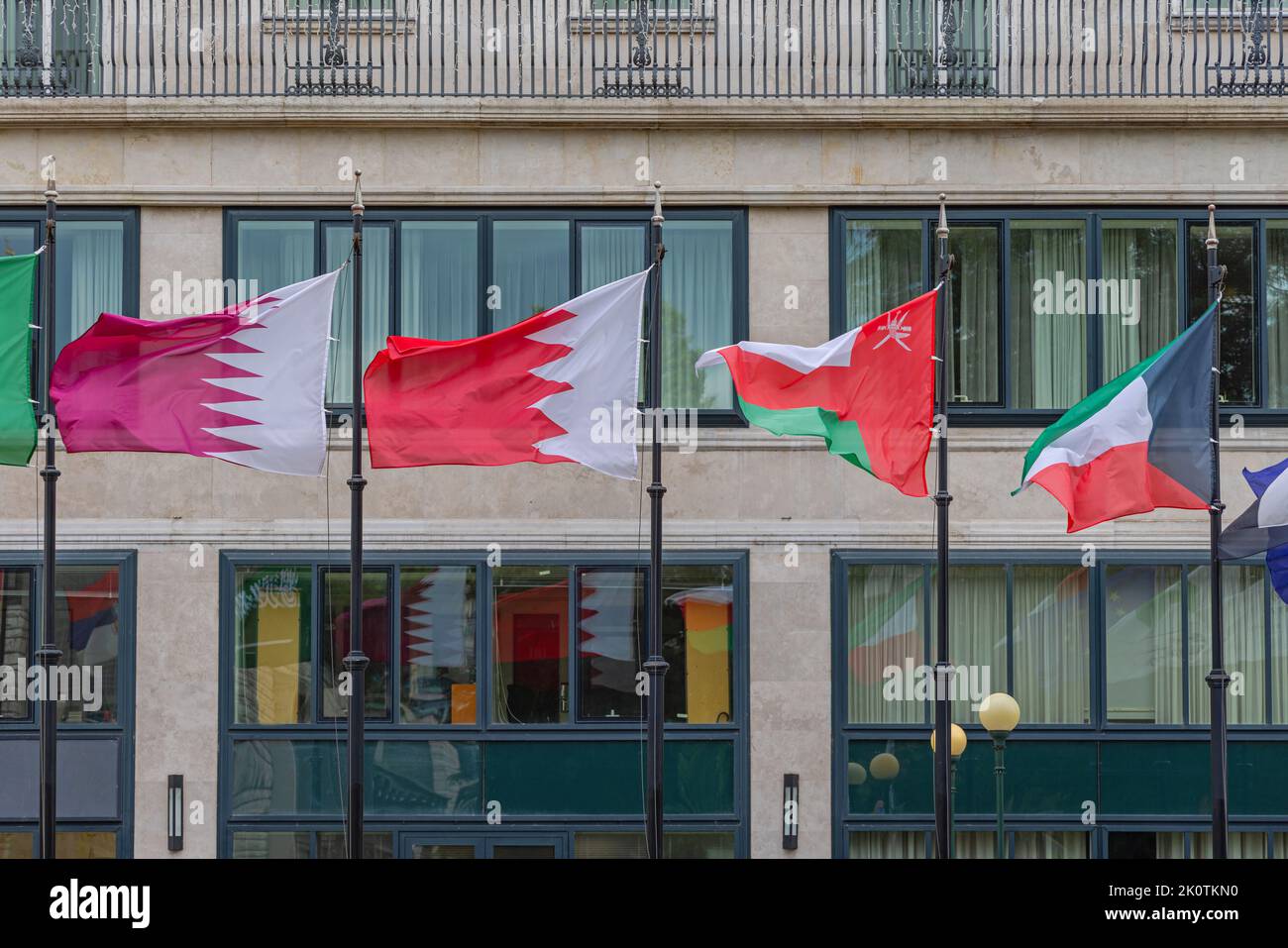 Qatar Bahrain Oman Kuwait Flags in Front of Hotel Building Stock Photo