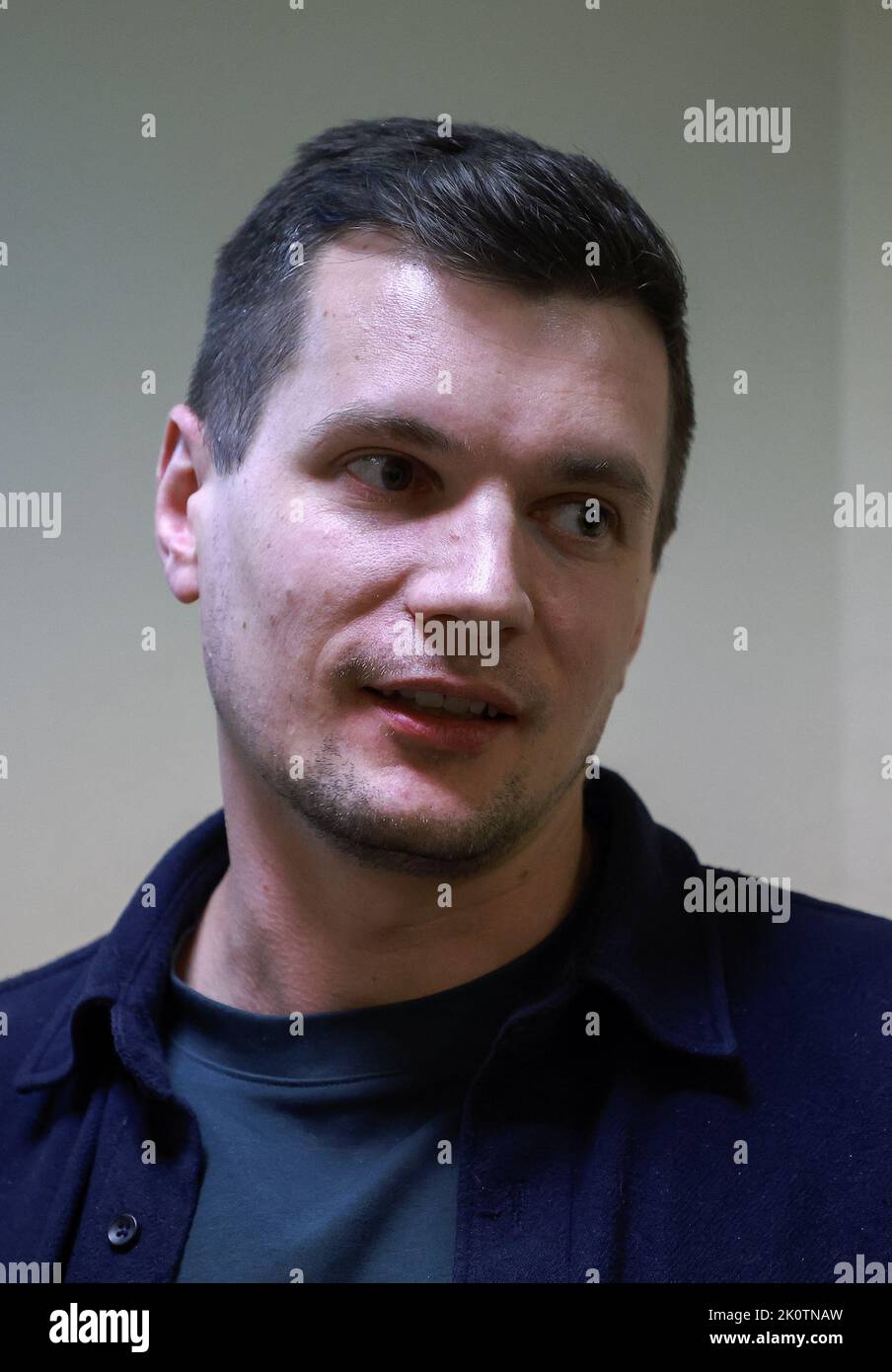 Member of the Smolninskoye municipality council Dmitry Palyuga, who was fined for public activity aimed at discrediting the Russian authorities amid Russia-Ukraine conflict, reacts inside a court building after a hearing in Saint Petersburg, Russia September 13, 2022. REUTERS/REUTERS PHOTOGRAPHER Stock Photo