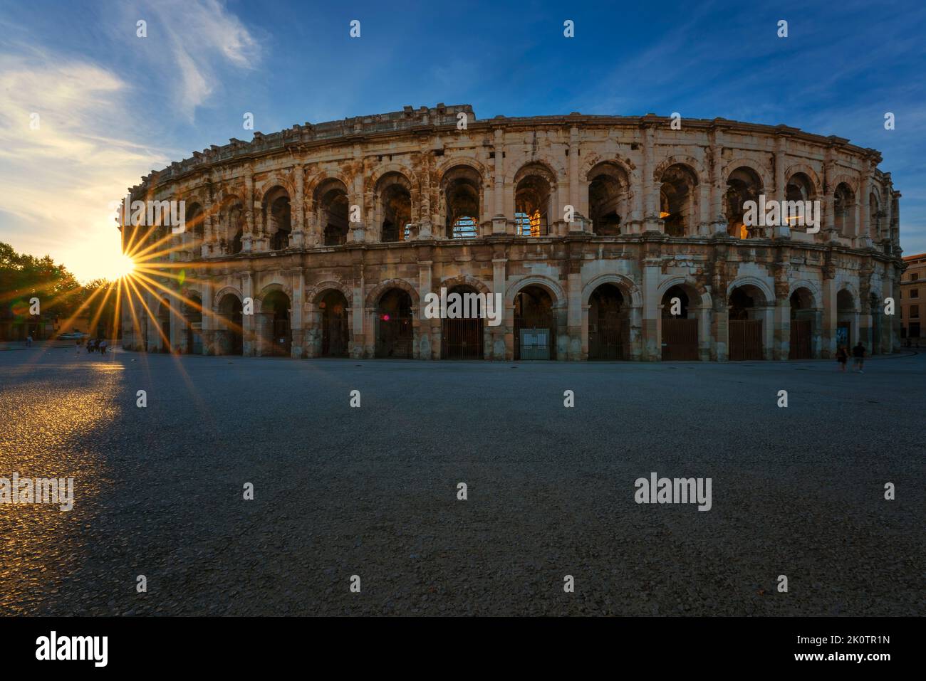 View of famous arena at sunset, Nimes, France Stock Photo