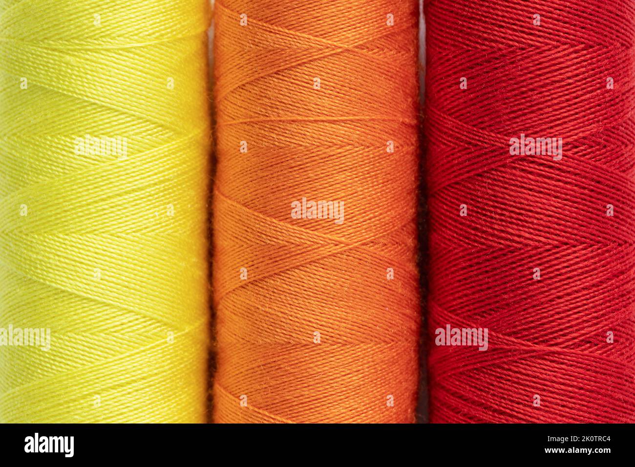 Colorful sewing thread spools close up. Full frame background, top view ...