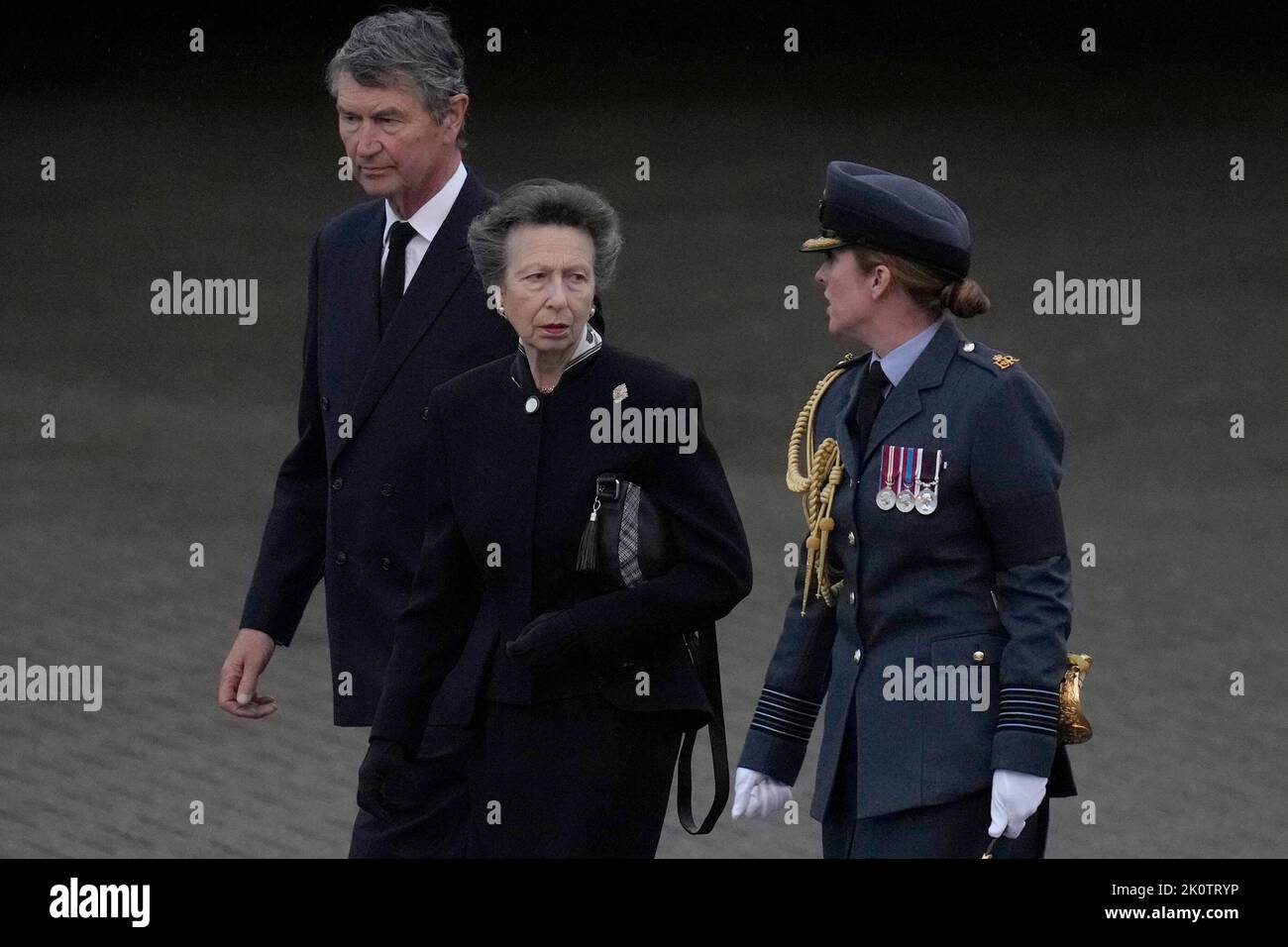 The Princess Royal and Vice Admiral Timothy Laurence are greeted by Station Commander Group Captain McPhaden having disembarked from the C-17 carrying the coffin of Queen Elizabeth II at the Royal Air Force Northolt, west London, from where it will be taken to Buckingham Palace, London, to lie at rest overnight in the Bow Room. Picture date: Tuesday September 13, 2022. Stock Photo