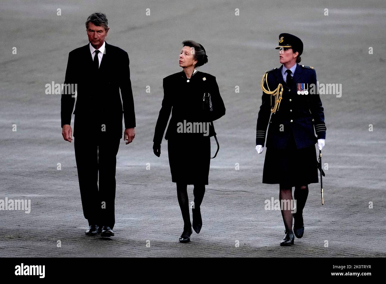 The Princess Royal and Vice Admiral Timothy Laurence are greeted by Station Commander Group Captain McPhaden having disembarked from the C-17 carrying the coffin of Queen Elizabeth II at the Royal Air Force Northolt, west London, from where it will be taken to Buckingham Palace, London, to lie at rest overnight in the Bow Room. Picture date: Tuesday September 13, 2022. Stock Photo