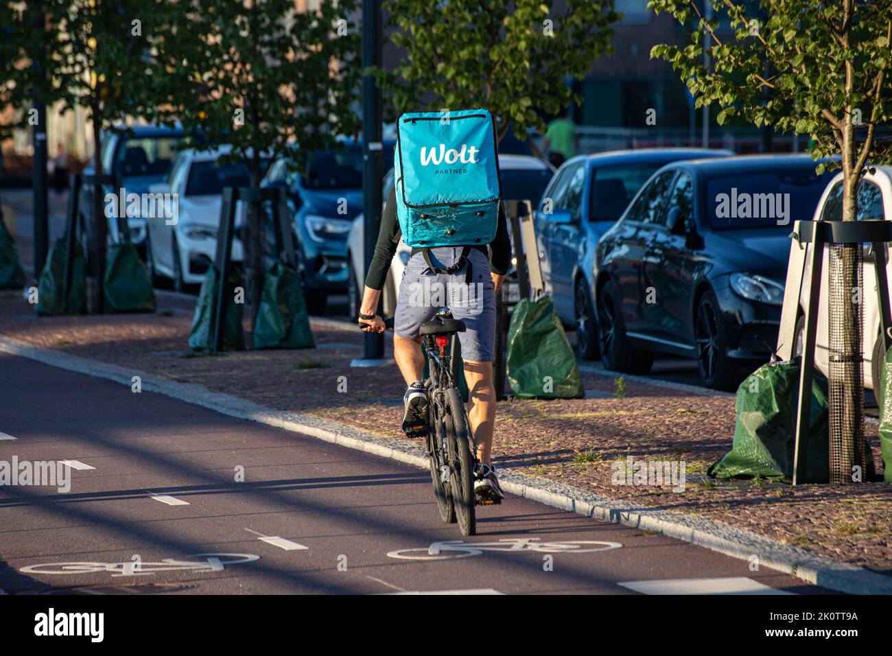 Wolt bicycle courier at work in Helsinki, Finland Stock Photo