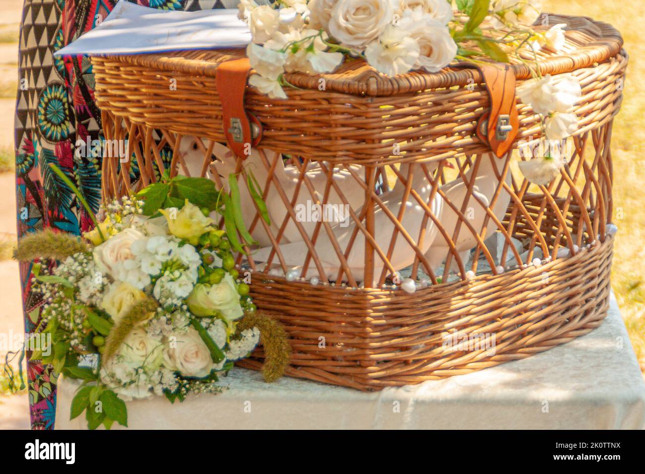 woven basket with white doves waiting for their flight at a wedding celebration Stock Photo