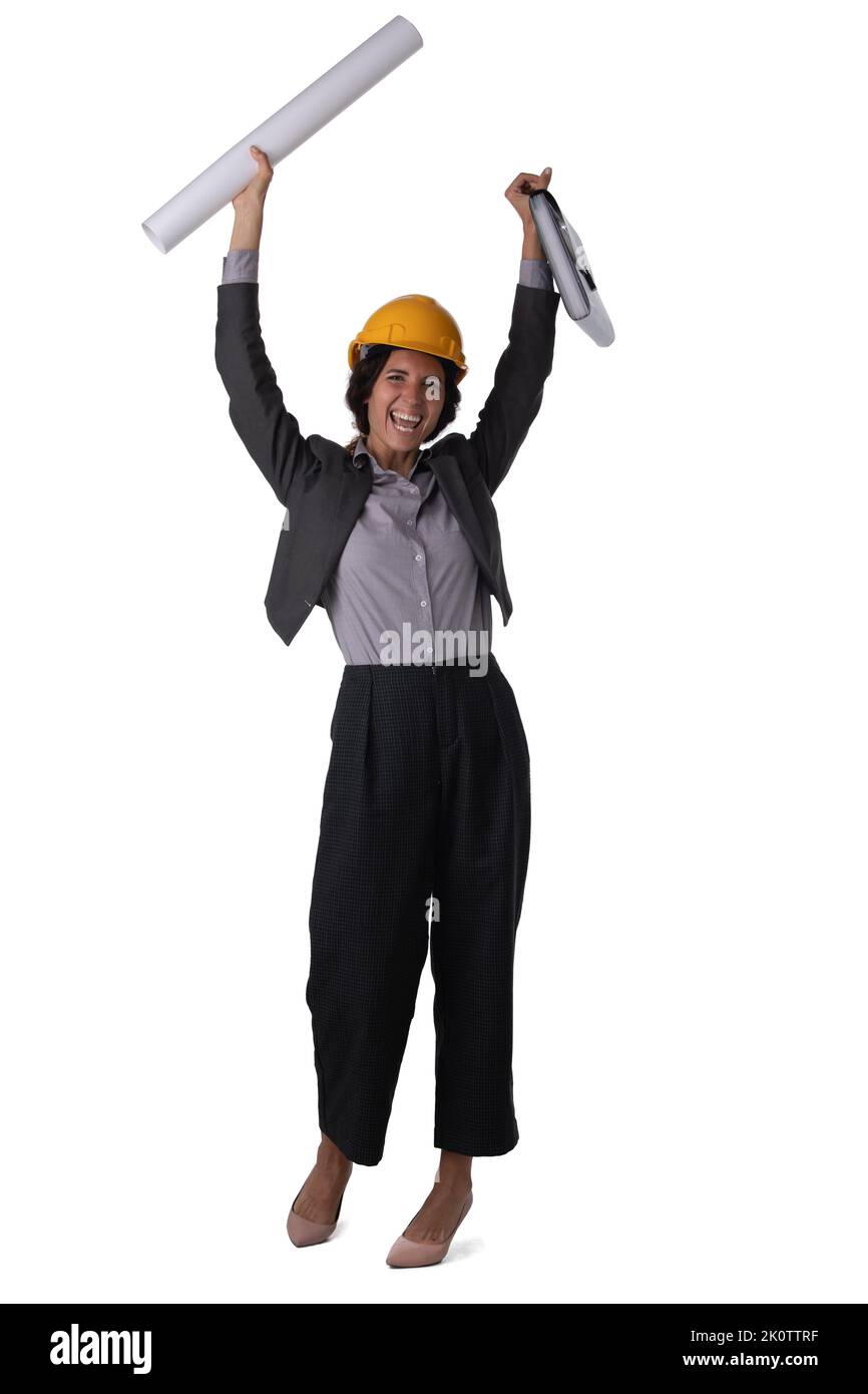 Portrait of female engeneer architect in yellow hardhat and business suit with raised arms isolated on white background full length studio portrait Stock Photo