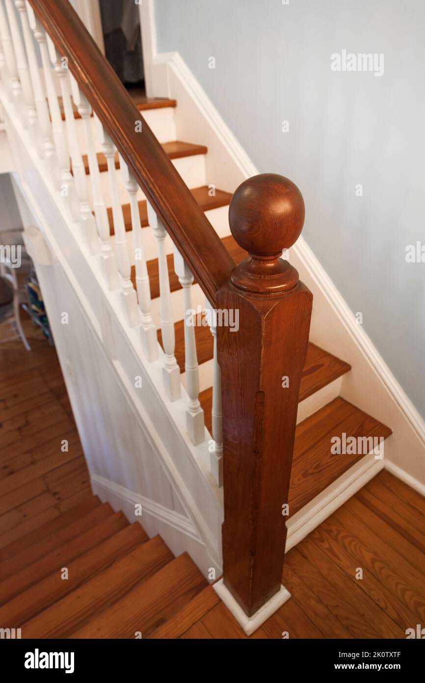 Old wooden staircase with post and spindles. Stock Photo