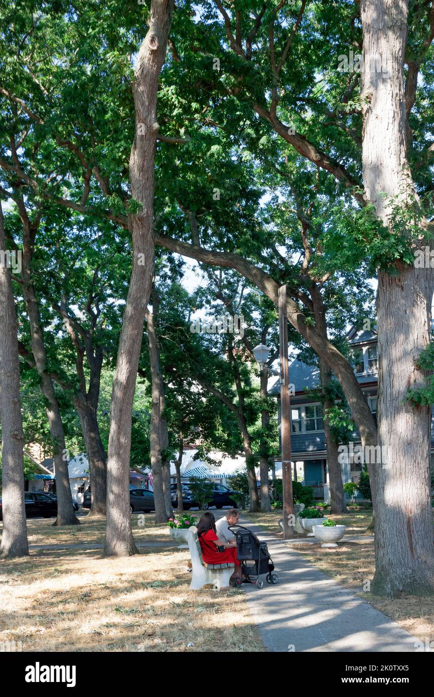 Couple sitting in Greenleaf Park in Ocean Grove, Neptune Township, Monmouth County, New Jersey, United States. Stock Photo