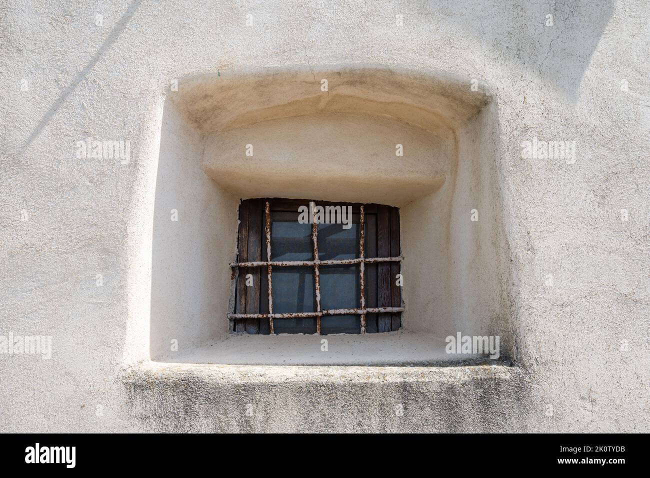 Small window set in an ancient wall. Stock Photo