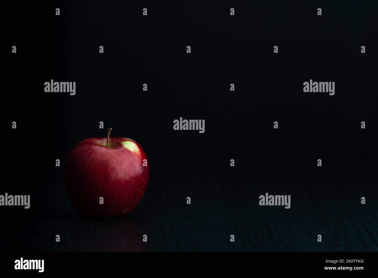 Fresh Ripe, Red Apple on Dark Black Background Stock Photo