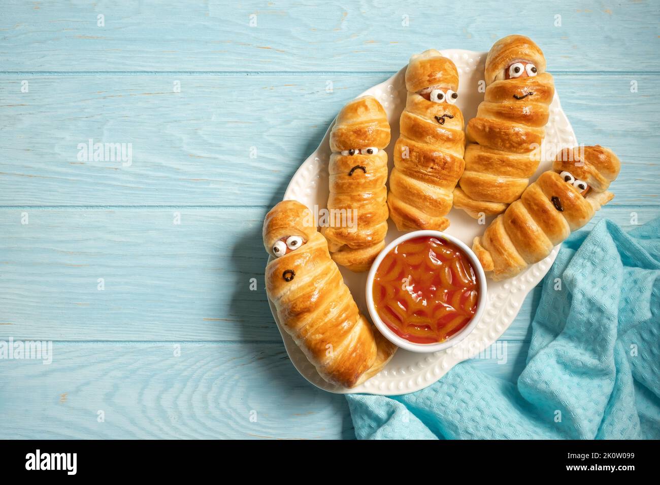 Mummy sausages scary halloween party food decoration wrapped in dough Stock Photo