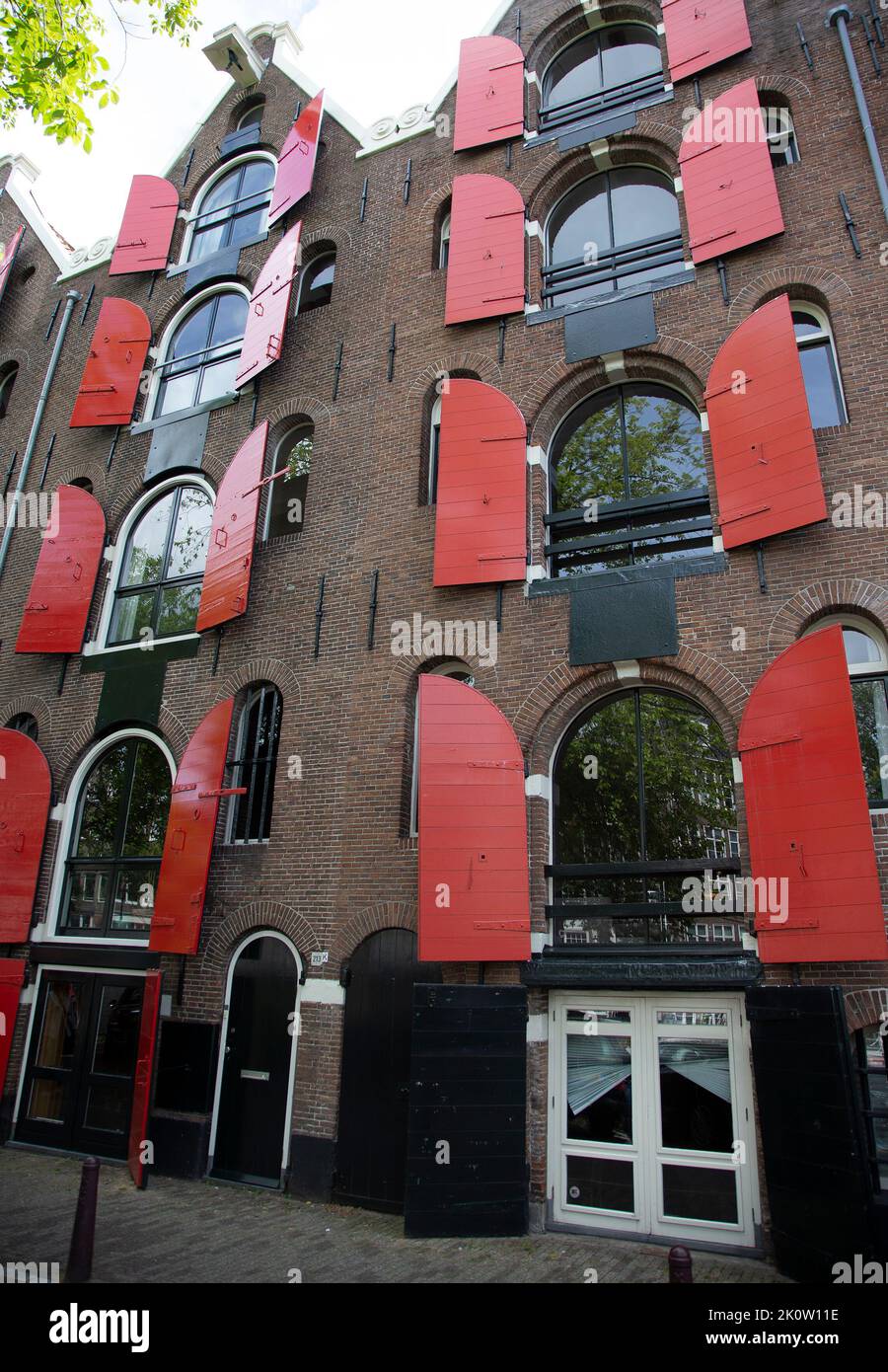 Building with red shutters in Amsterdam Stock Photo