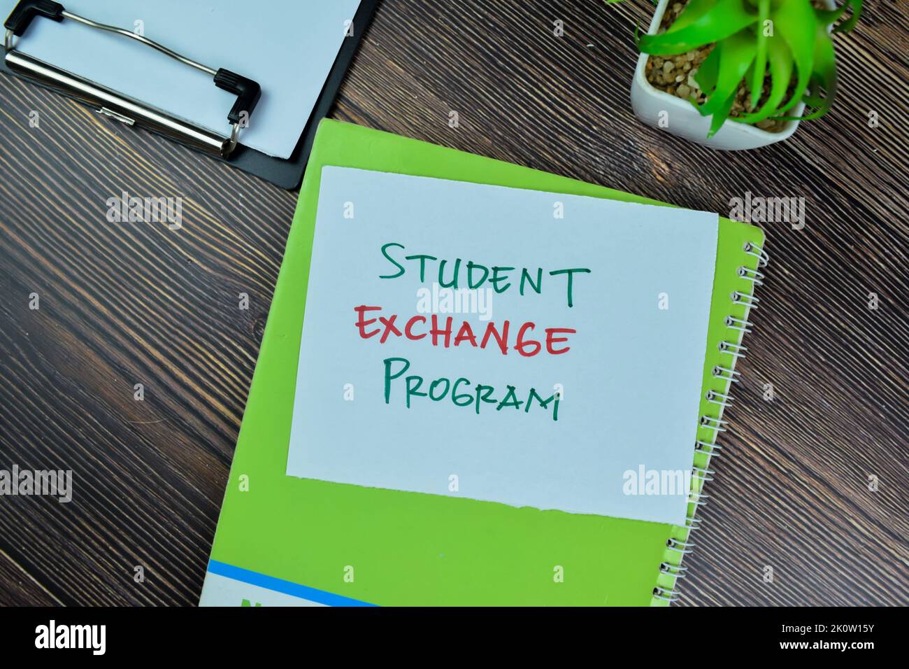 Concept of Student Exchange Program write on sticky notes isolated on Wooden Table. Stock Photo