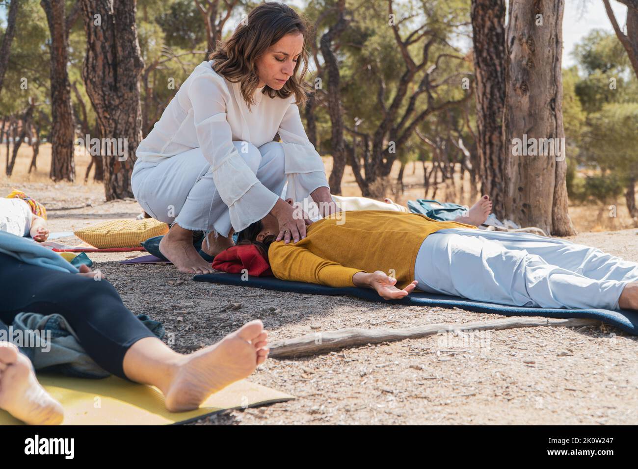 Mindfulness coach touching one of the therapy s participant to help