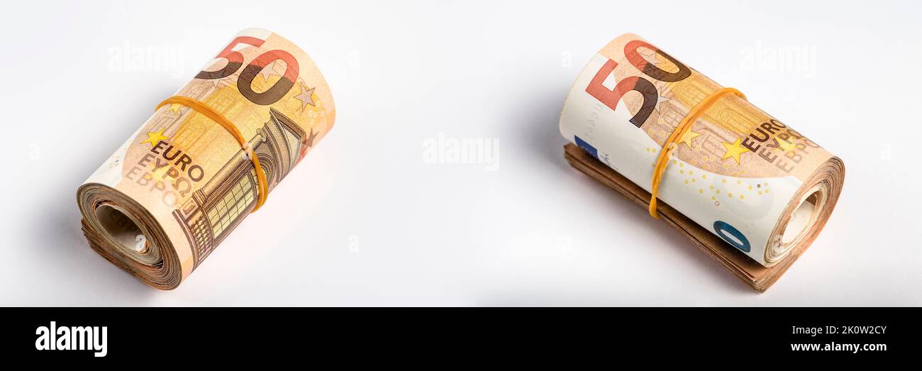 Roll of money. Roll of 50 euro banknotes. Euro banknotes rolled up on a gray background. The concept of financial assistance, real estate purchase Stock Photo