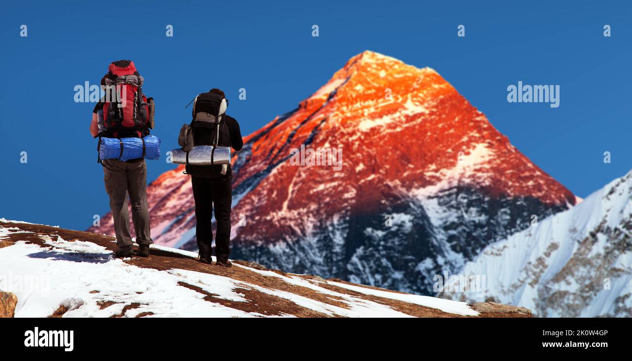 Evening colored view of Mount Everest from Gokyo valley with two tourist on the way to Everest base camp, Sagarmatha national park, Khumbu valley, Sol Stock Photo
