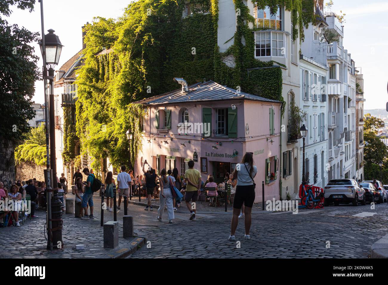 Paris, France - July, 15: Cozy old street with pink house restaurant called La Maison Rose at the quarter Montmartre in Paris on July 15, 2022 Stock Photo