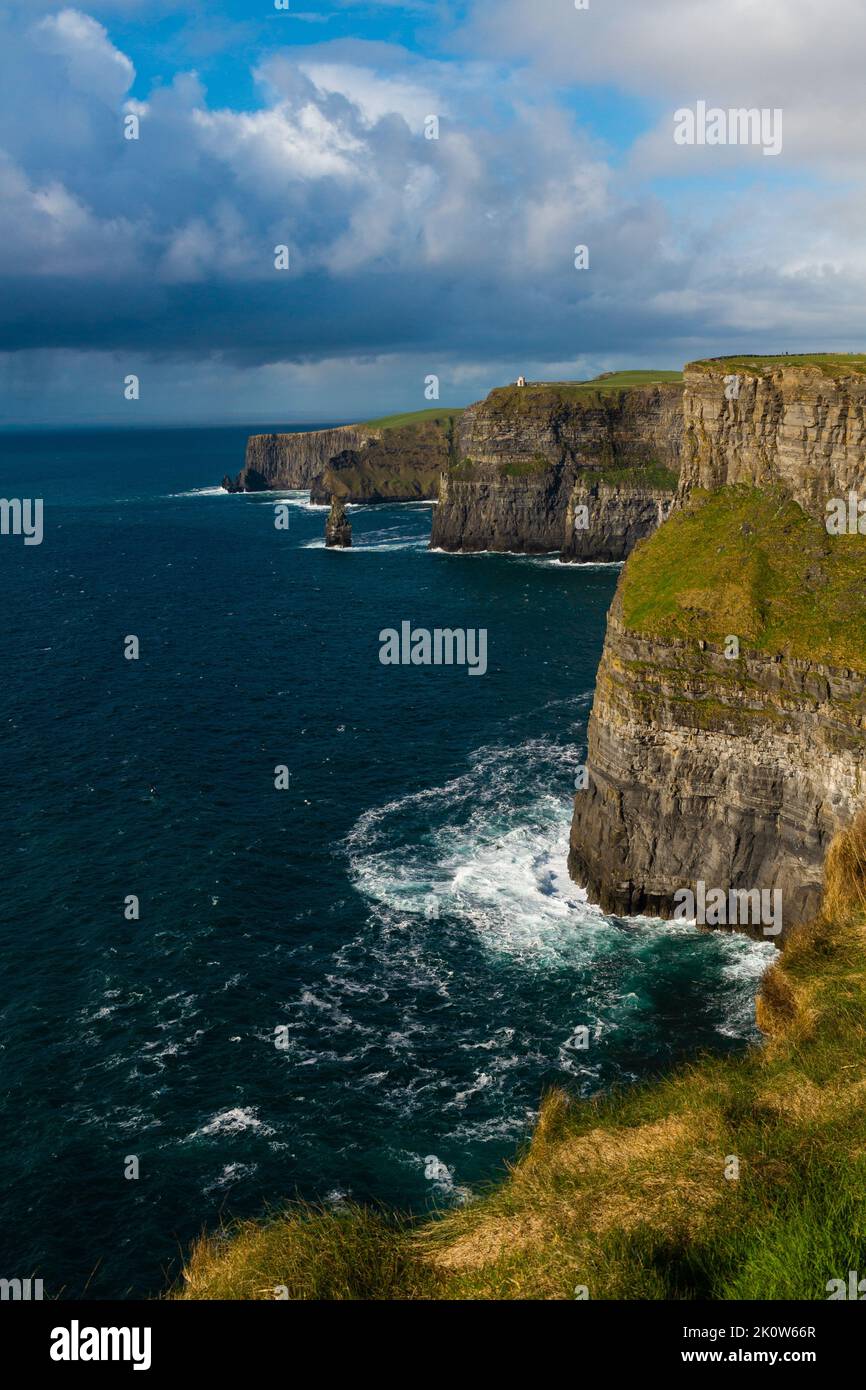 A vertical shot of the rocky cliff and the sea Stock Photo - Alamy