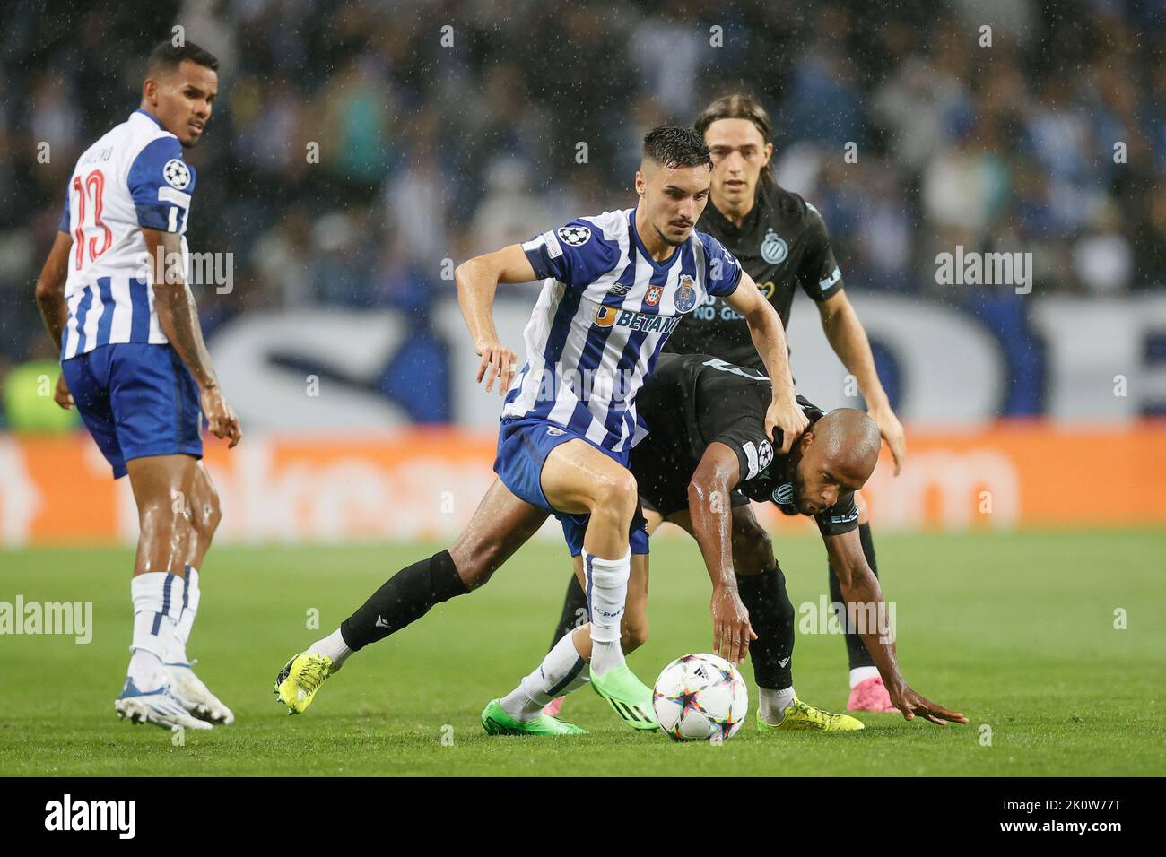 Porto, Portugal. 13th Sep, 2022. Porto's Stephen Eustaquio and Club's Denis  Odoi fight for the ball during the match between Belgian soccer team Club  Brugge KV and Portuguese FC Porto, Tuesday 13