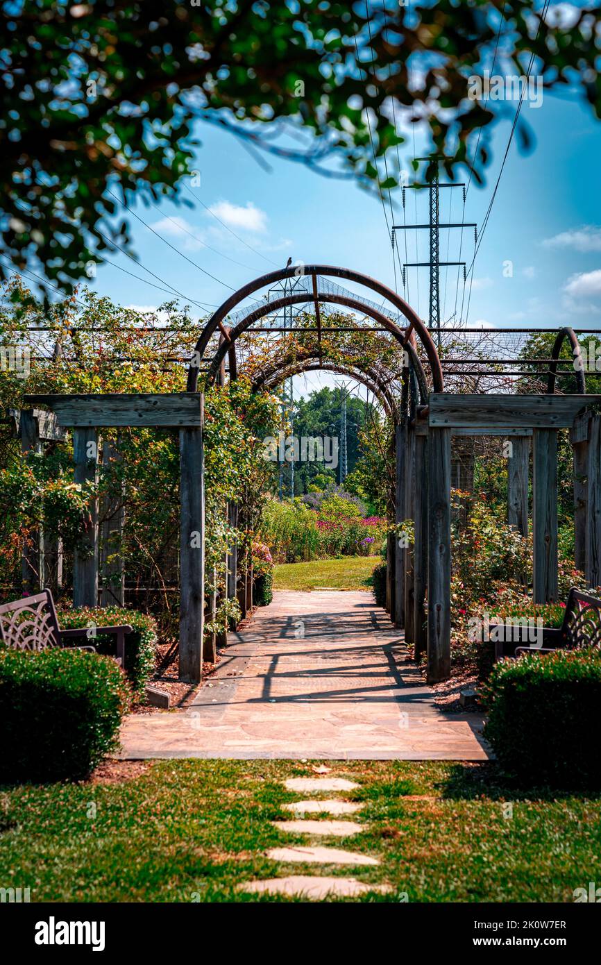 An entrance arch and pathway in a park, vertical shot Stock Photo - Alamy