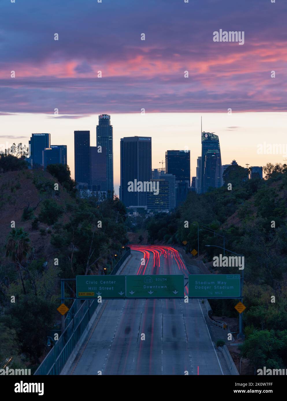 Light trails on the 110 freeway leading into downtown Los Angeles at sunset Stock Photo