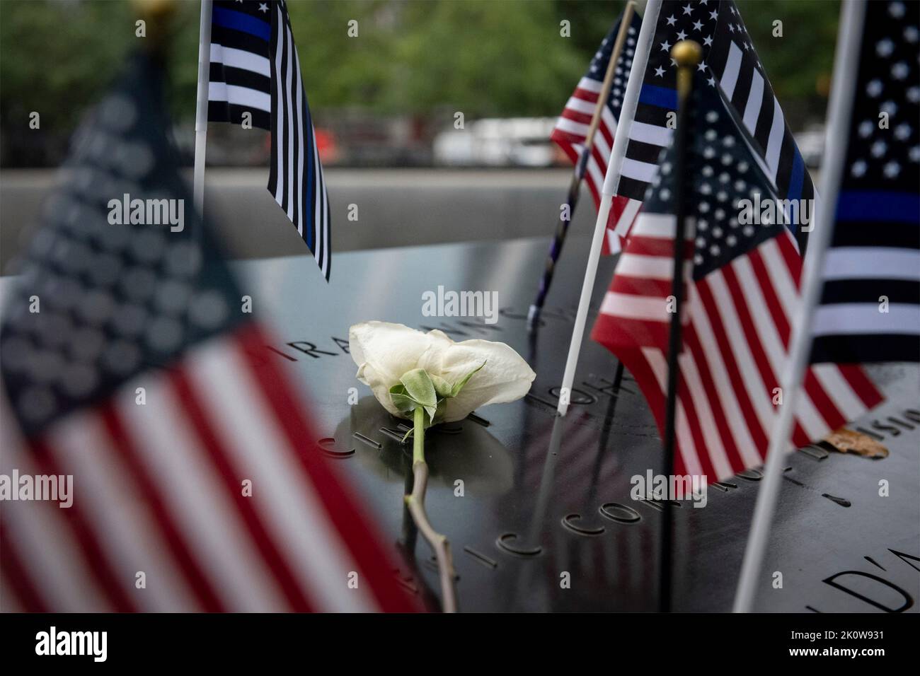 New York, United States of America. 11 September, 2022. Flowers and flags placed on the name of Secret Service Special Officer Craig Miller by U.S Homeland Security Secretary Alejandro Mayorkas, during the ceremony remembering the victims of the 9/11 attacks at the National September 11 Memorial Museum, September 11, 2022 in New York City. The nation marked the 21st anniversary of the al-Qaida terrorists attacks that killed nearly 3,000 people.  Credit: Sydney Phoenix/DHS Photo/Alamy Live News Stock Photo
