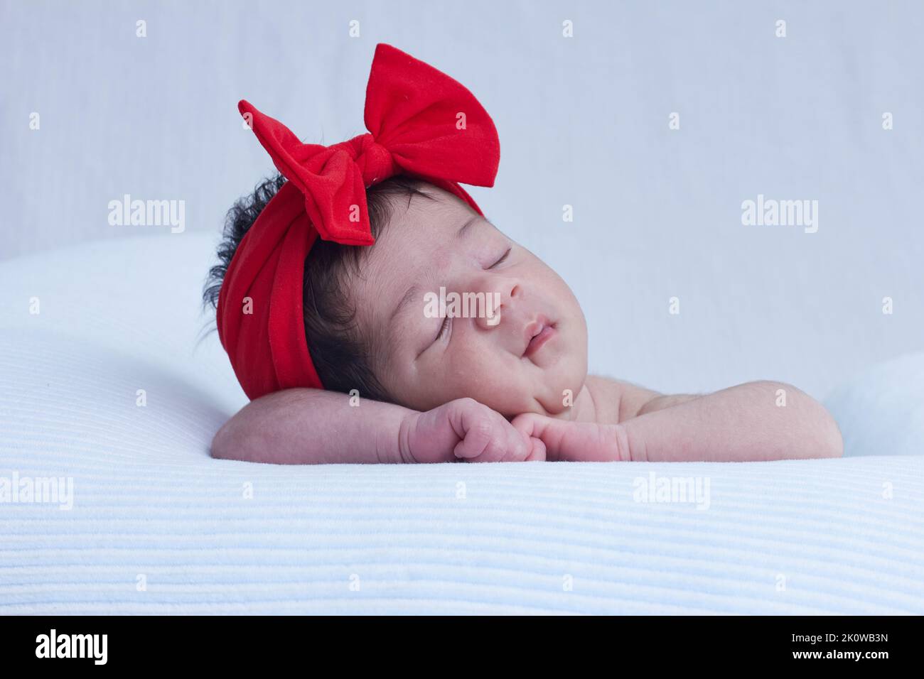 new born baby sleeping and dreaming. baby resting on a cousin, top