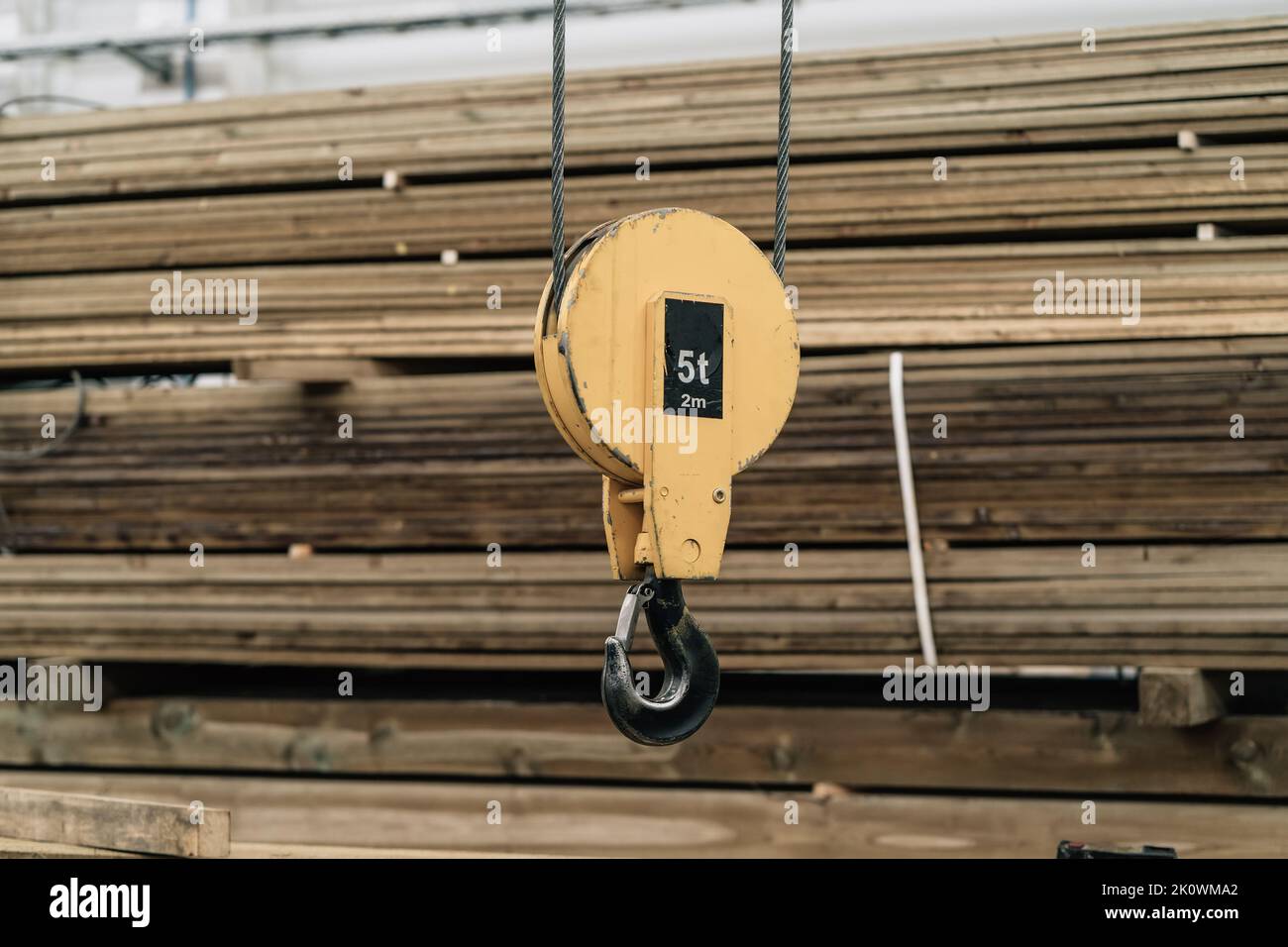 Hook of overhead beam crane in factory close-up. Stock Photo