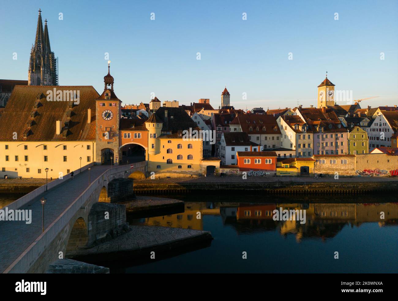 Regensburg, Germany, September 5th 2022. Drone aerial shot of the riverfront with the old stone bridge, main cathedral, town hall, and other buildings Stock Photo
