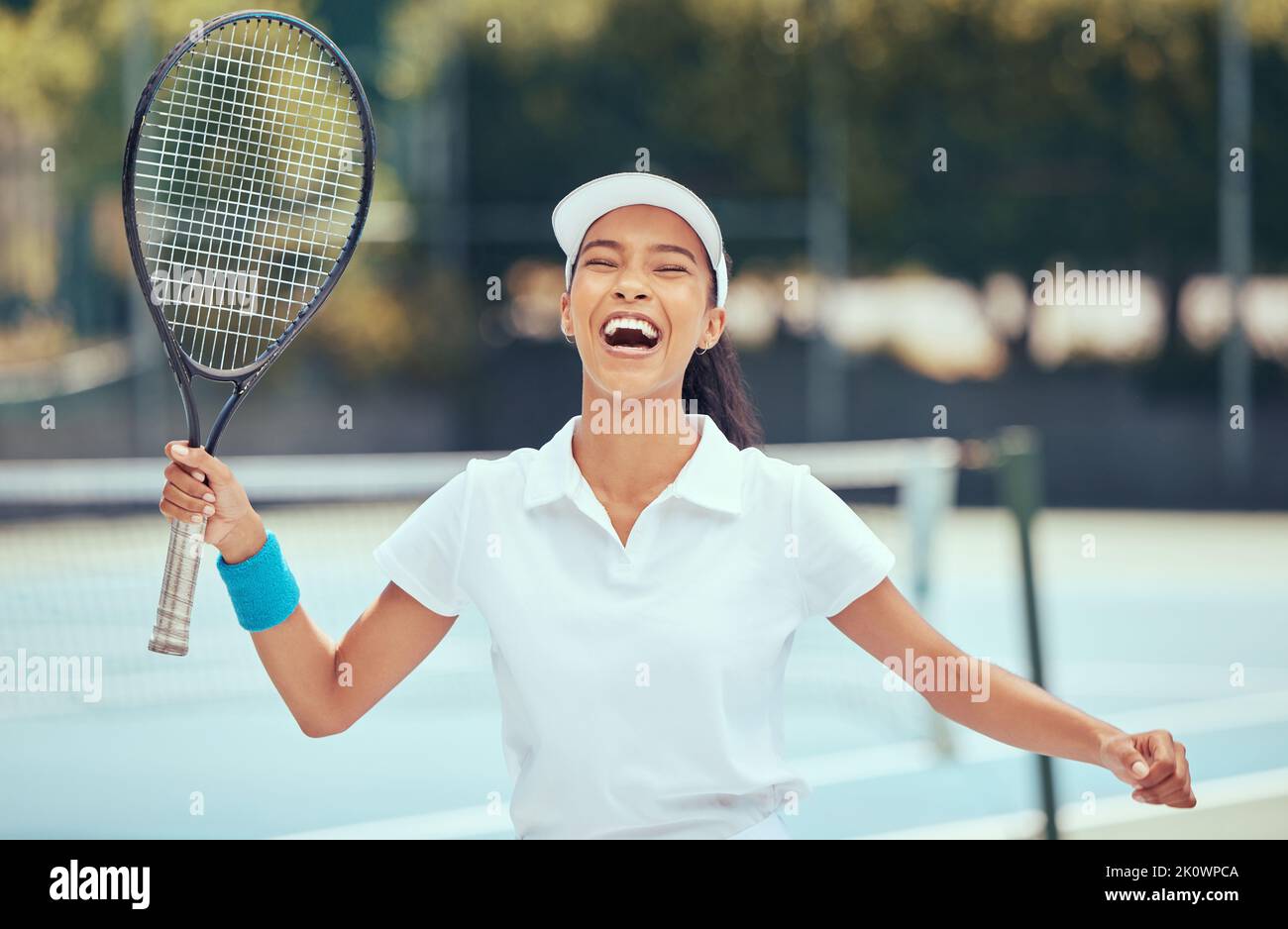 Victory, winner and tennis player woman celebrating with racket after winning a competition or tournament match at an outdoor court. Happy, excited Stock Photo