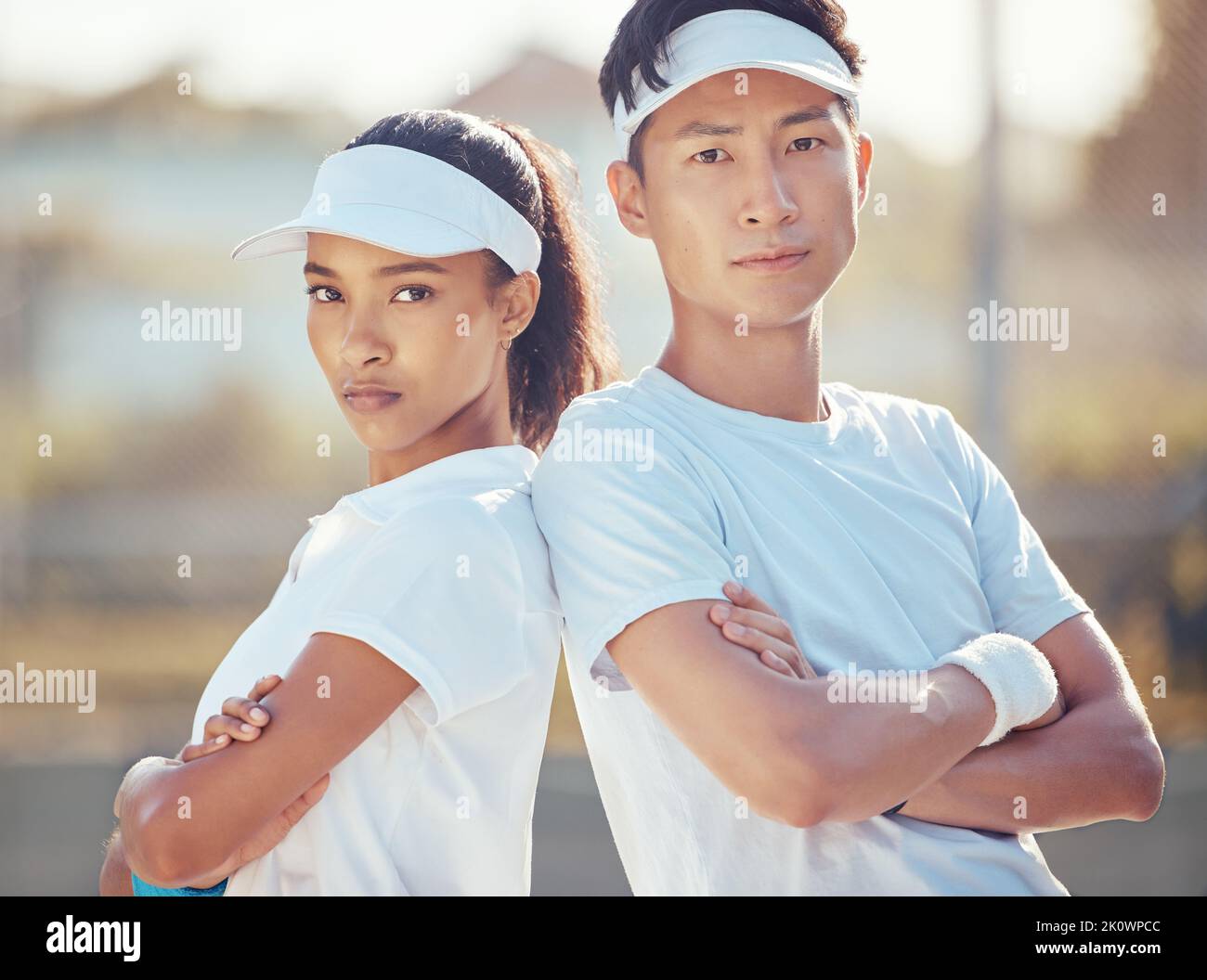 Tennis team, competitive sport and serious man and woman ready for a game or match on an outdoor court. Fitness with players standing together for Stock Photo