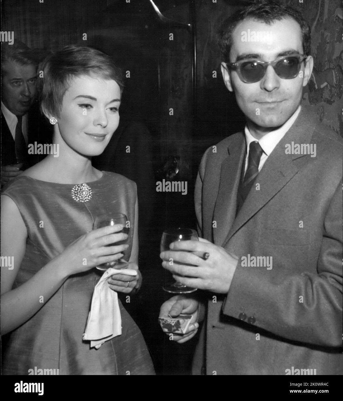 March 3, 1960, Paris, France: JEAN-LUC GODARD And JEAN SEBERG toasting with champagne the release of his new film ''A Bout De Souffle'' (Breathless): JEAN-LUC GODARD, the well-known French film director, invited the press for a cocktail party to celebrate the release of his new film ''A Bout De Souffle'' (Breathless) starring Jean Seberg. (Credit Image: © Keystone Press Agency/ZUMA Press Wire) Stock Photo