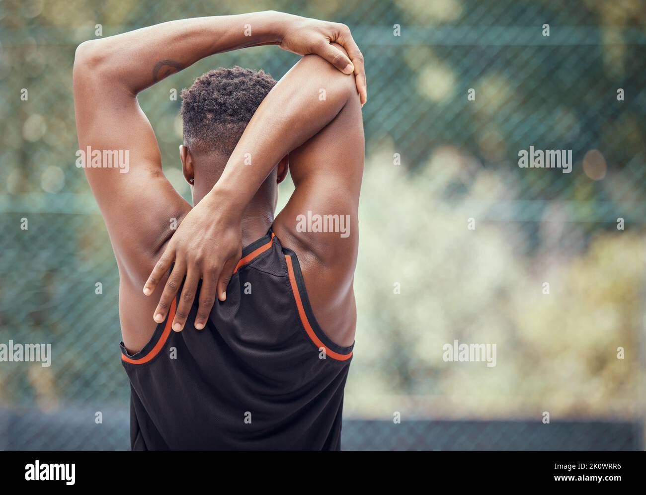 Sports, exercise and training with a man stretching to warmup for sport or fitness outside. Workout, healthy and performance with a male athlete Stock Photo