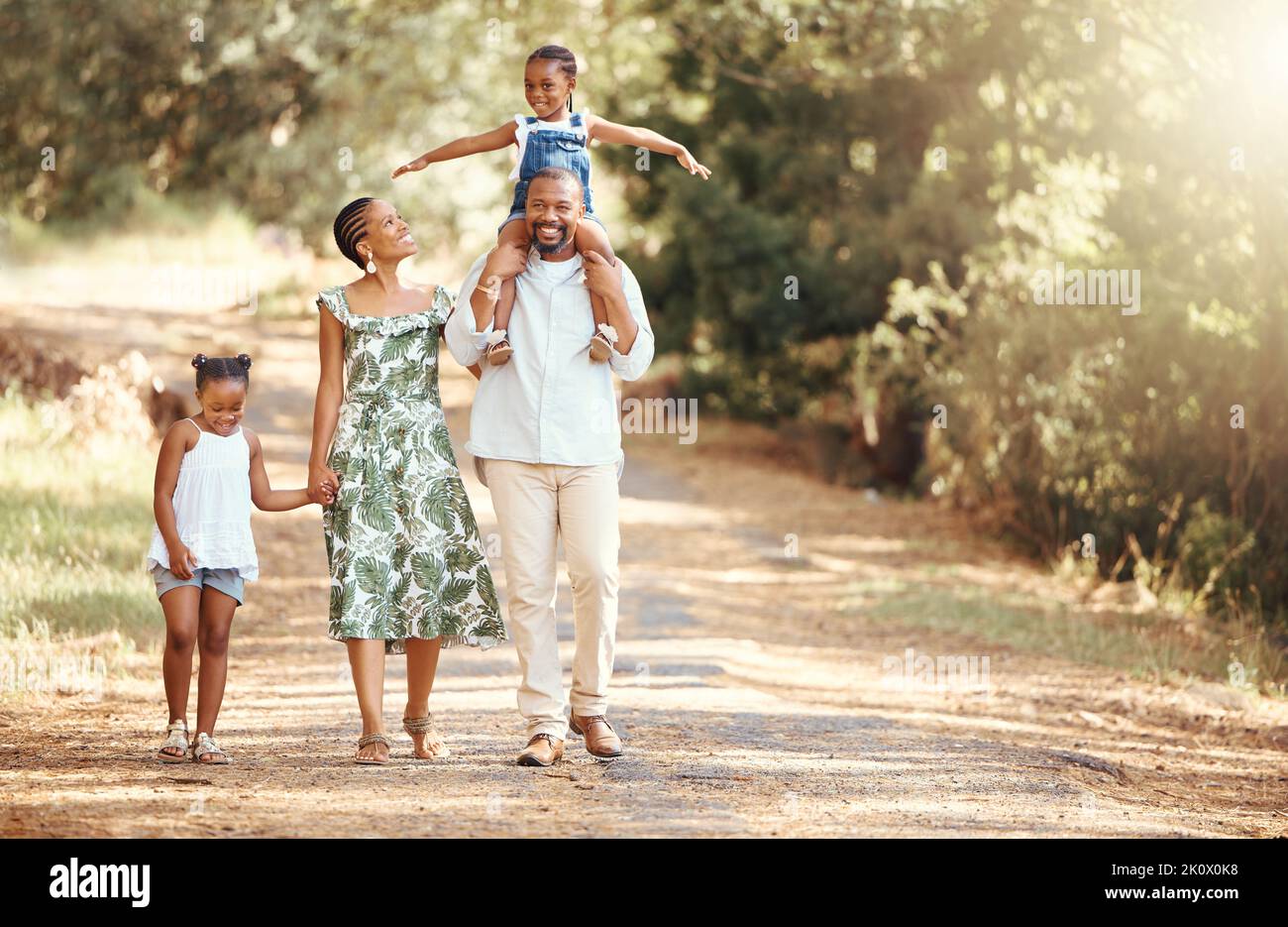 Happy black family bonding on an outdoor work in a park, loving and having fun together. African American parents enjoying fresh air and an active Stock Photo