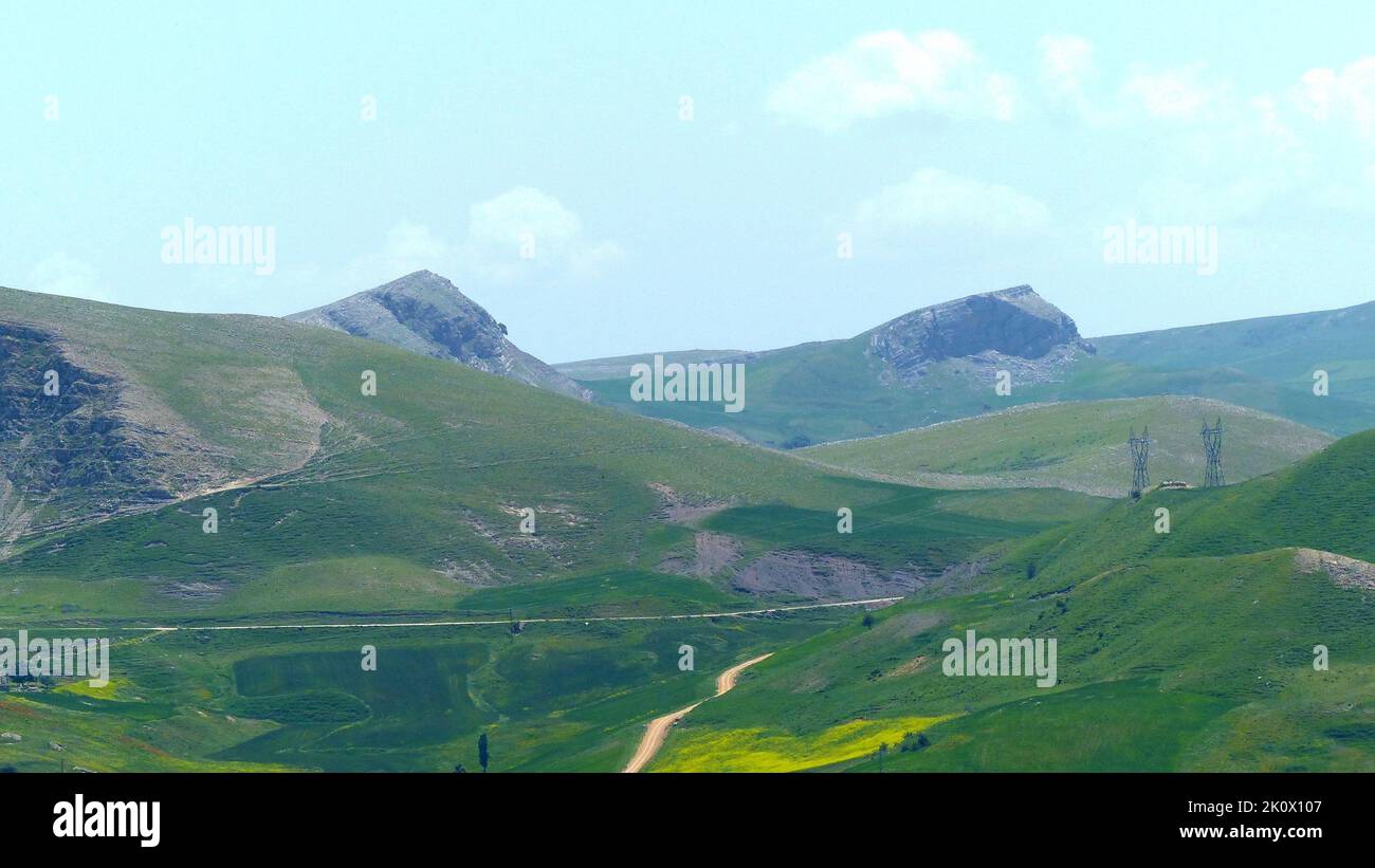 A mesmerizing view of green hills under a cloudy sky in natural area ...