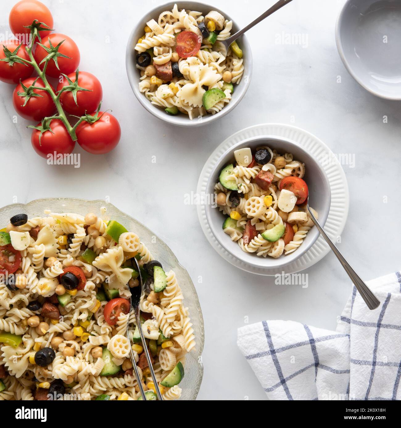 Two small bowls of fresh homemade pasta salad with the remaining salad