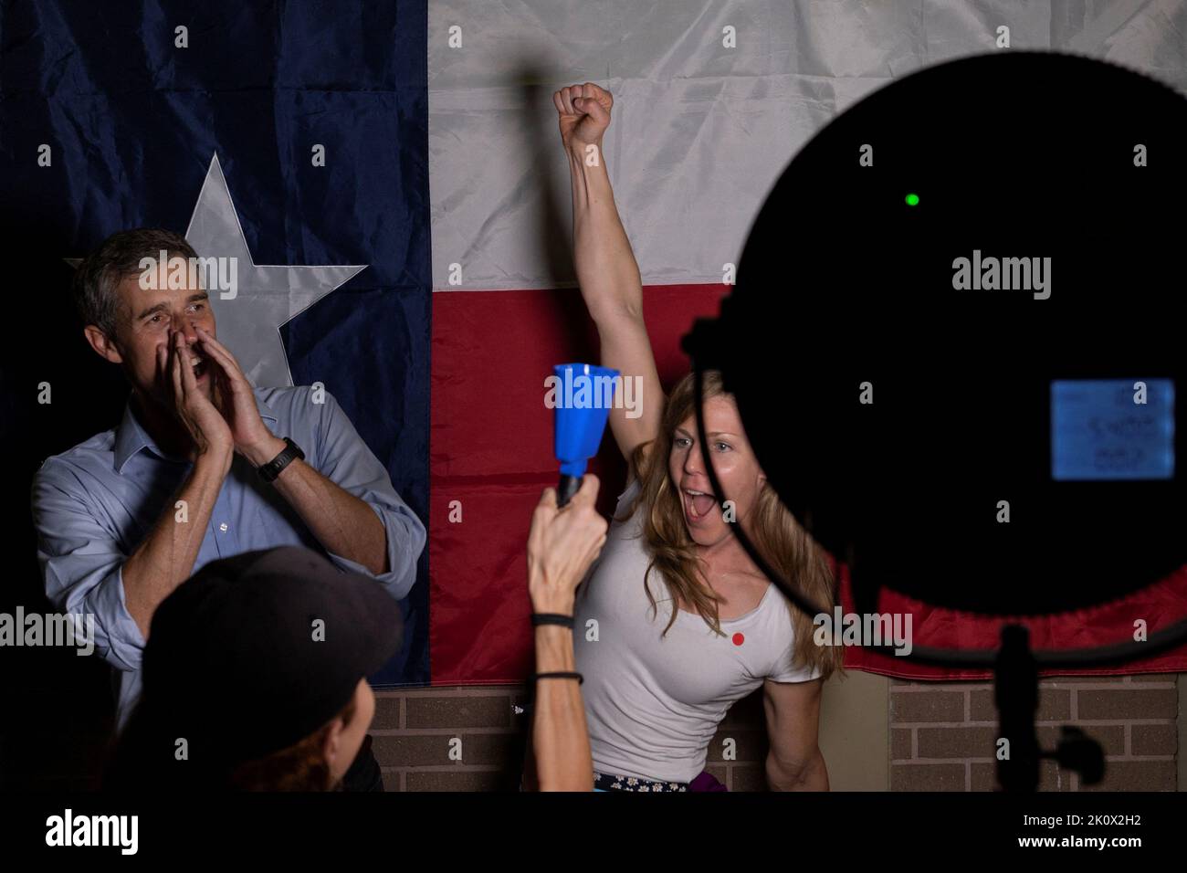 Marika Mohr, an American from Finland, raises her hand as Texas Democratic gubernatorial candidate and former U.S. congressman Beto O'Rourke shouts, 'First time voter,' before posing with supporters in front of the Texas state flag during a campaign event in Houston, Texas, U.S. September 13, 2022. REUTERS/Adrees Latif     TPX IMAGES OF THE DAY Stock Photo