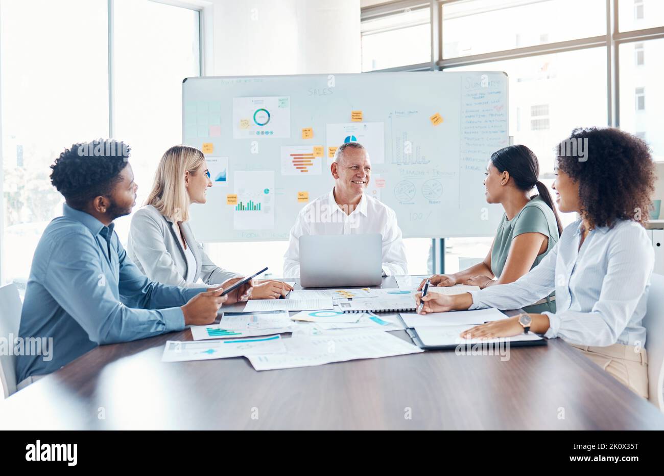 Planning, thinking and strategy by team collaboration on financial analysis in a corporate office. Happy business people smiling and looking positive Stock Photo