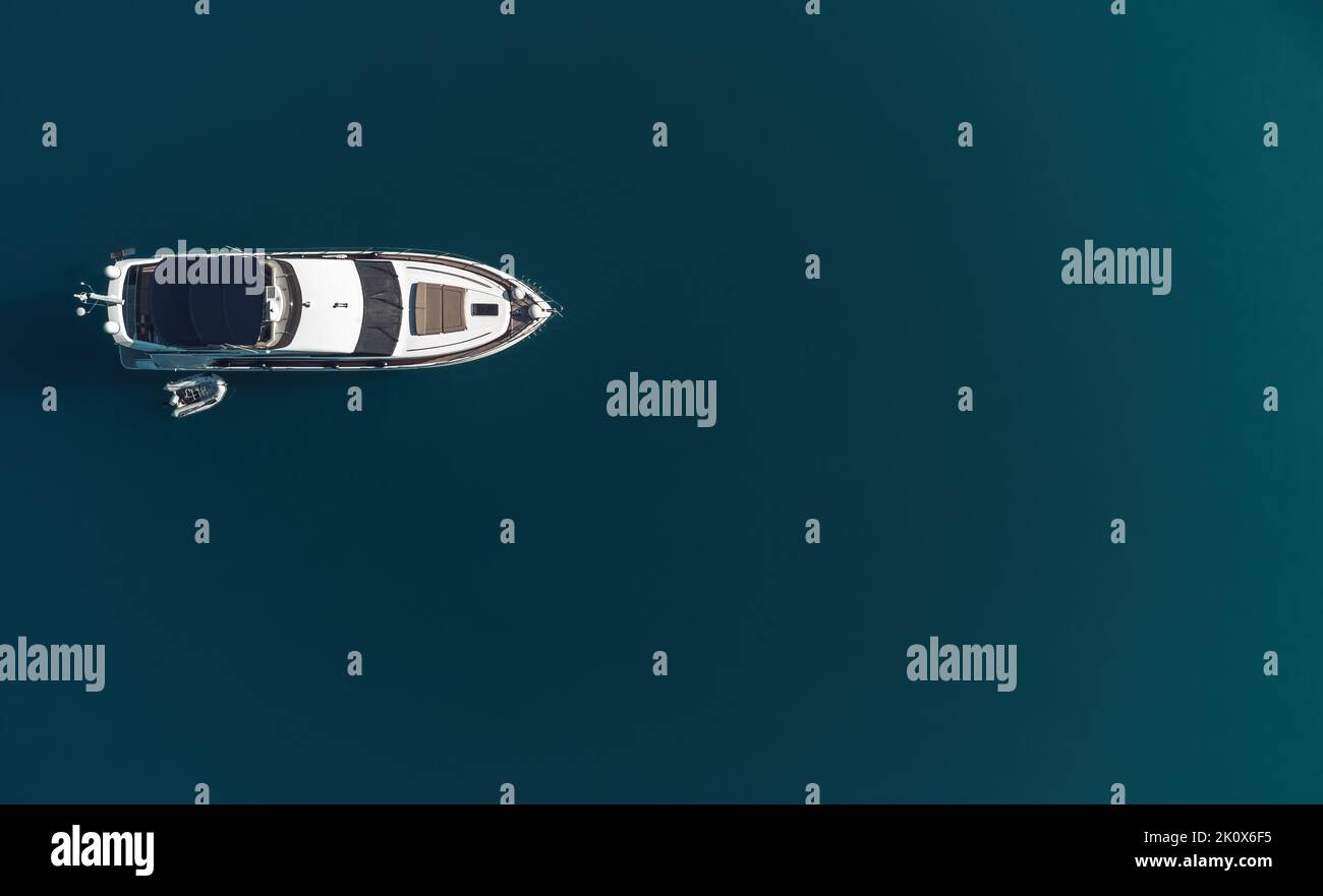 Aerial yacht on calm sea. Luxury cruise trip. View from above of white ...