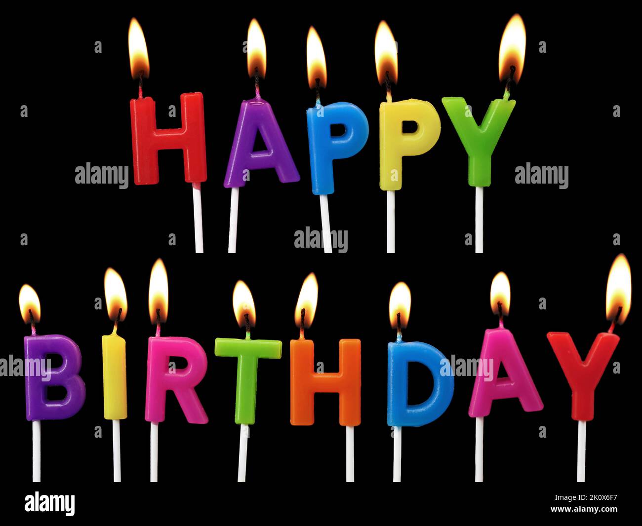 colorful burning Happy Birthday candles isolated on black background
