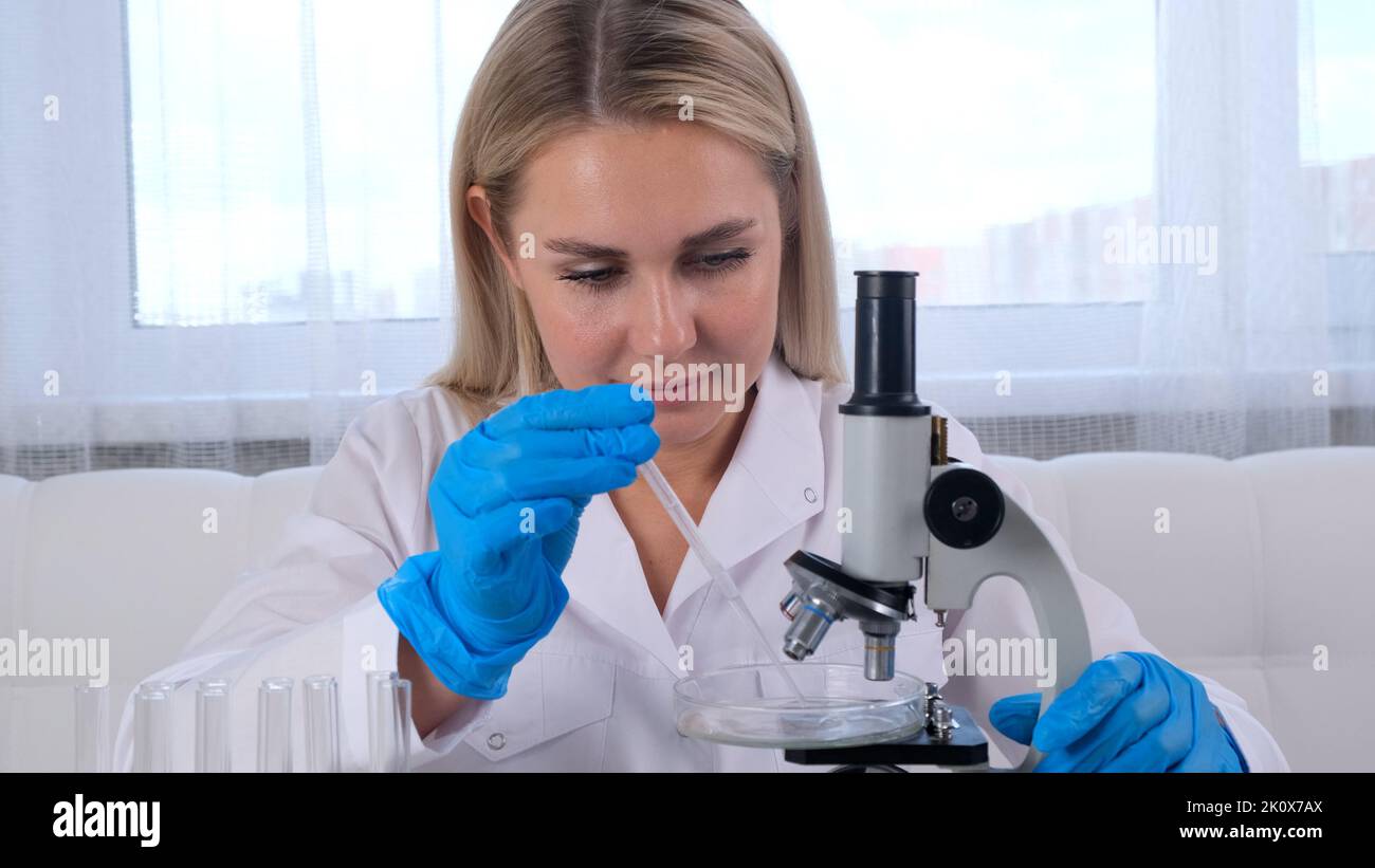 Microchemists professional scientist takes a sample for a medical experiment. A ...