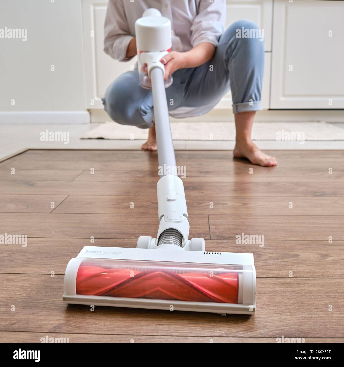 Happy woman with Xiaomi Mi Handheld Vacuum Cleaner G10 cleans home kitchen  - Moscow, Russia, June 19, 2022 Stock Photo - Alamy