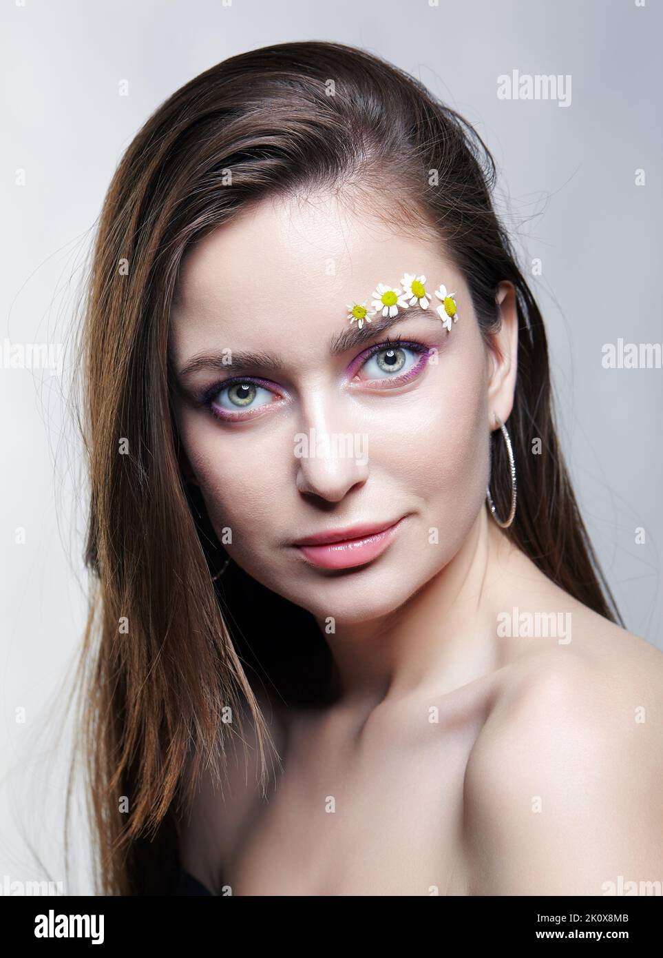 Female with long brown hair posing on gray background. Woman with brows ...