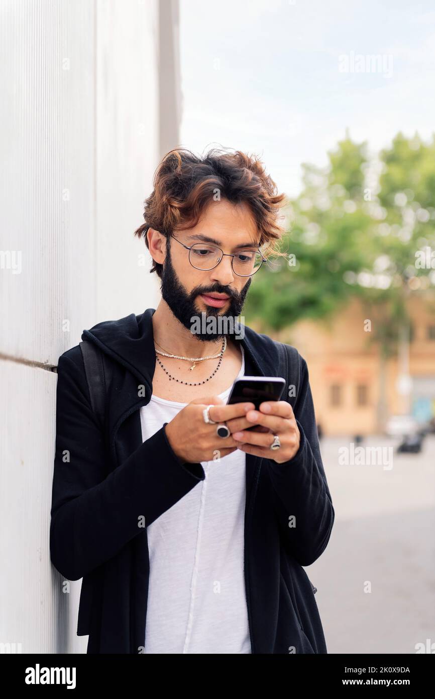 stylish young man typing on mobile phone Stock Photo
