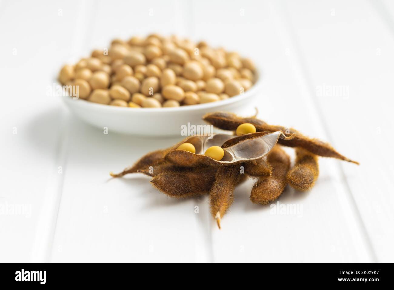 Soy beans. Dried soybean pod on the white table. Stock Photo