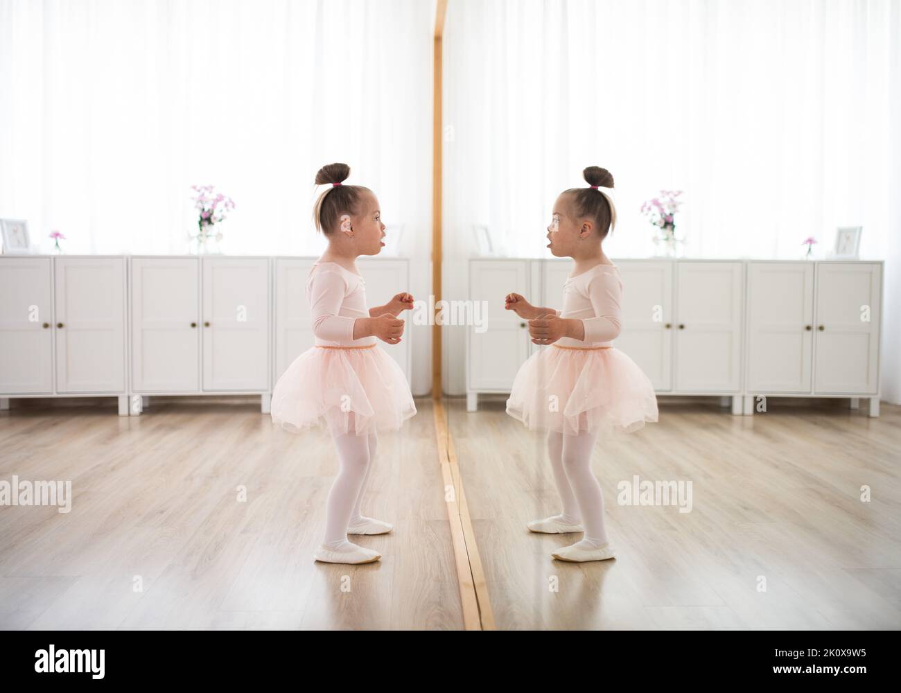 Little girl with down syndrome at ballet class in dance studio