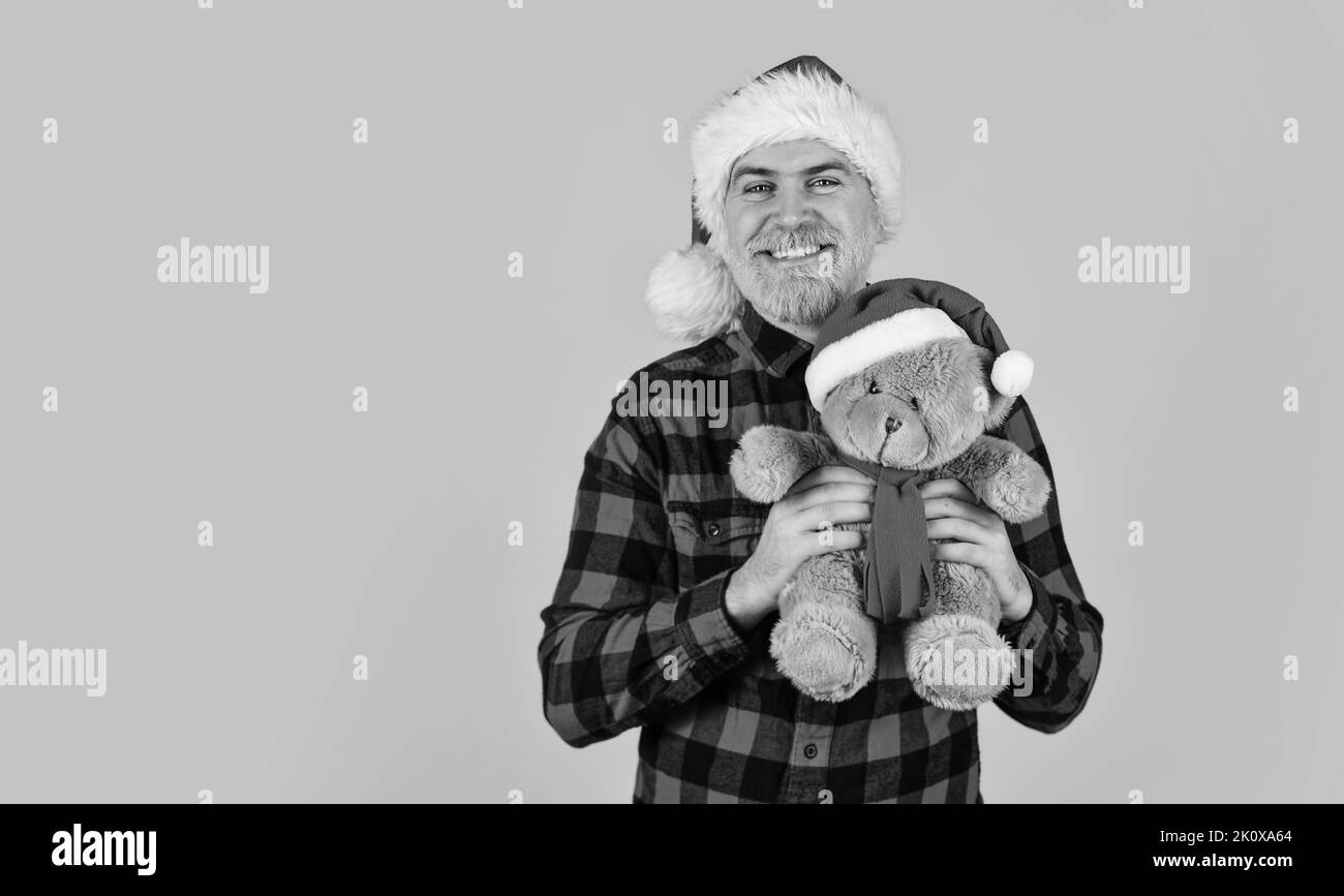 Charity project. Bearded man celebrate christmas. Kind hipster with teddy bear. Charity and kindness. Lovely hug. Santa Claus. Mature man with long Stock Photo