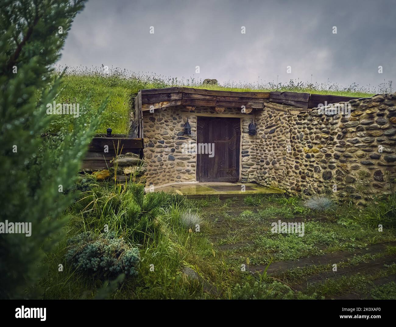 A hobbit house hidden underground part of the Clay Castle from the Valley of Fairies, a touristic complex in Transylvania, Romania Stock Photo